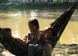 Kids enjoying themselves by the river in Siam Reap, Cambodia